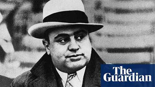 Black and white close-up of Al Capone's face. He is wearing a light-colored fedora with a black band around it, and he is looking off to his left. The Guardian logo is in the lower right in color.