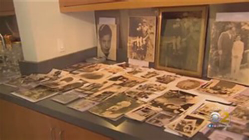 A collection of various Al Capone family photos spread out and propped up on a counter.